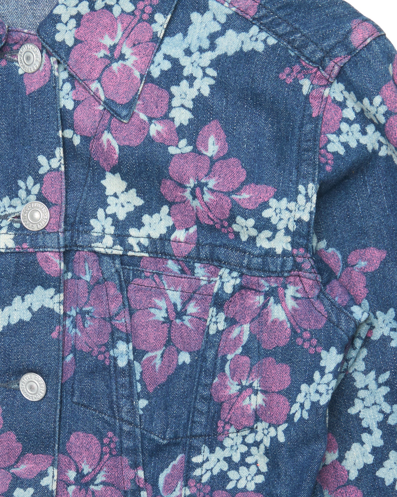 Floral patterned denim jacket with pink and white flowers on a blue background