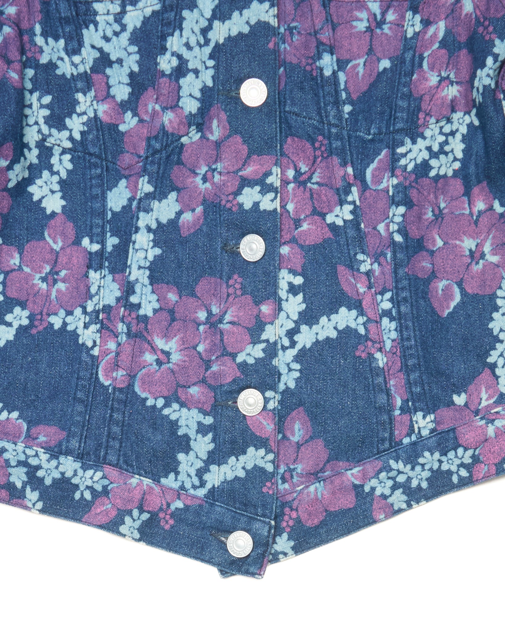 Close-up of a denim jacket with floral pattern and buttons