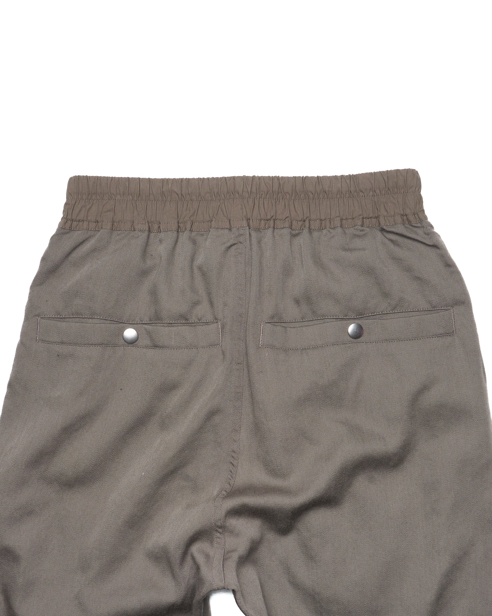 Back view of gray shorts with a white background