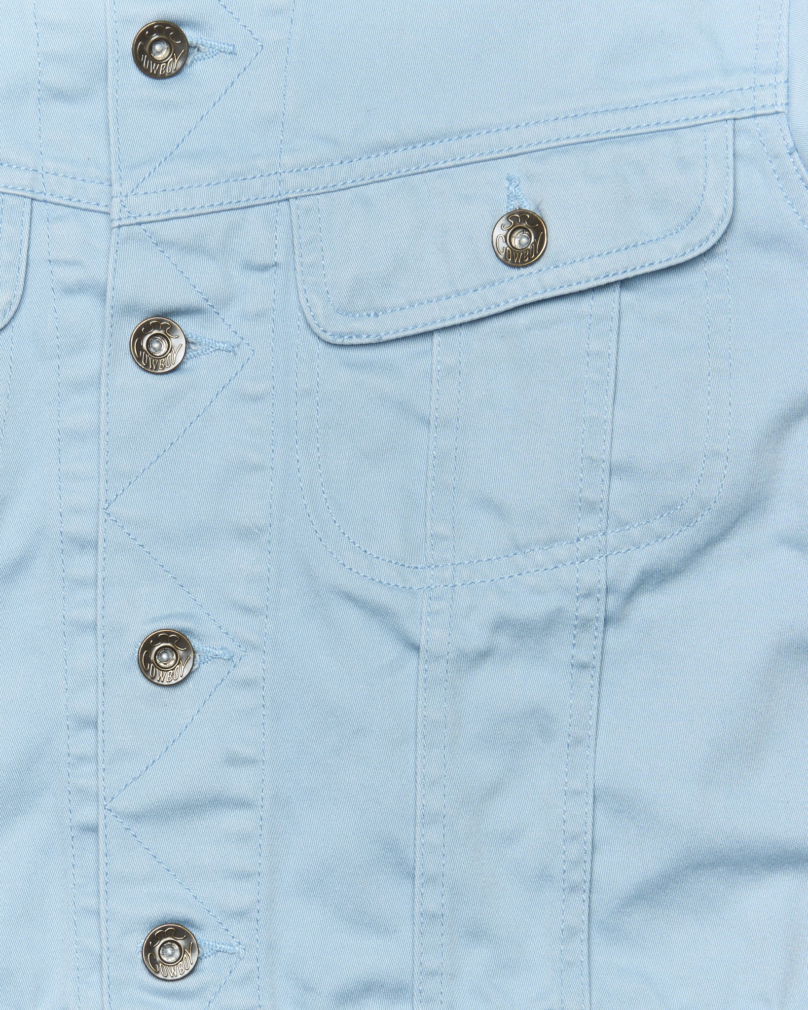 Close-up of a light blue denim jacket with button details