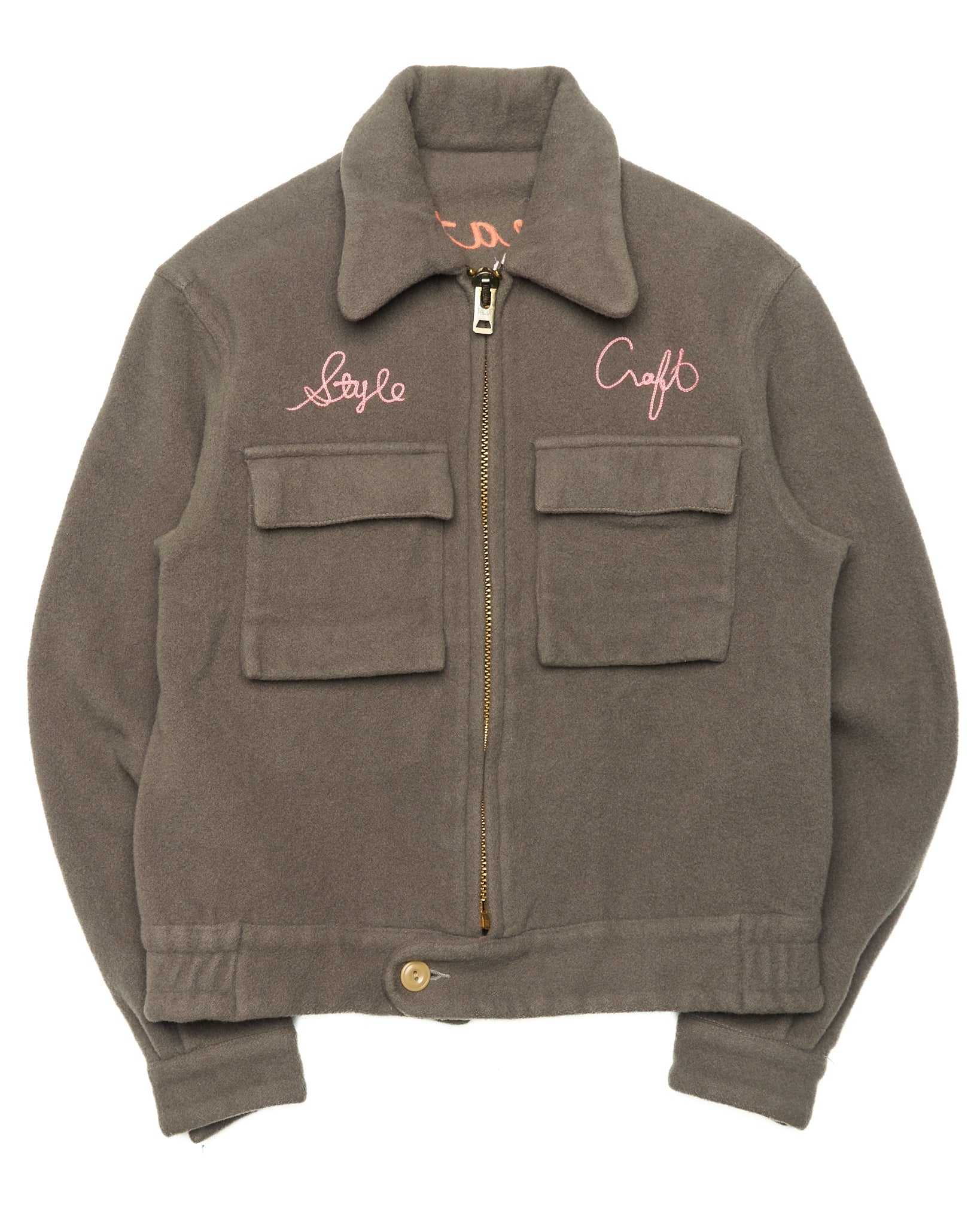 Brown jacket with embroidered text on a white background