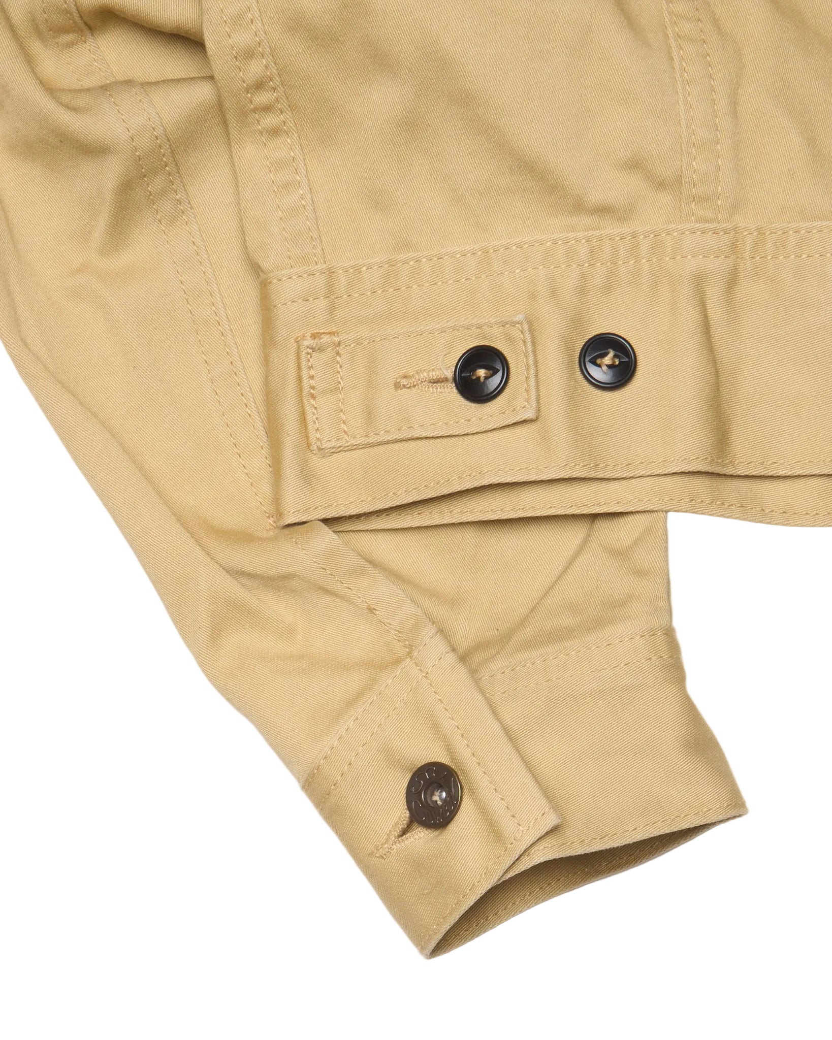 Close-up of beige jacket with button details on a white background