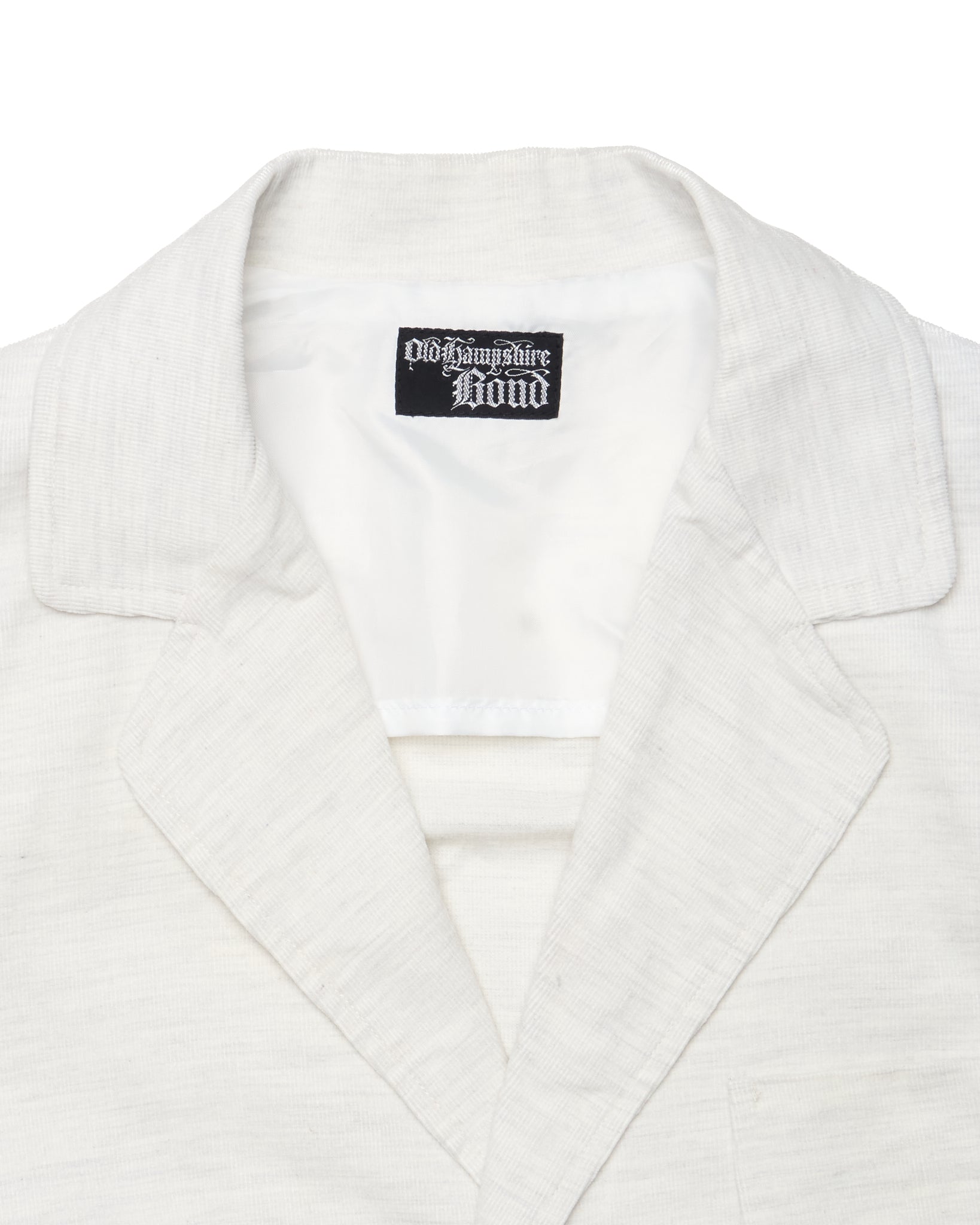 White blazer with a brand label on a white background