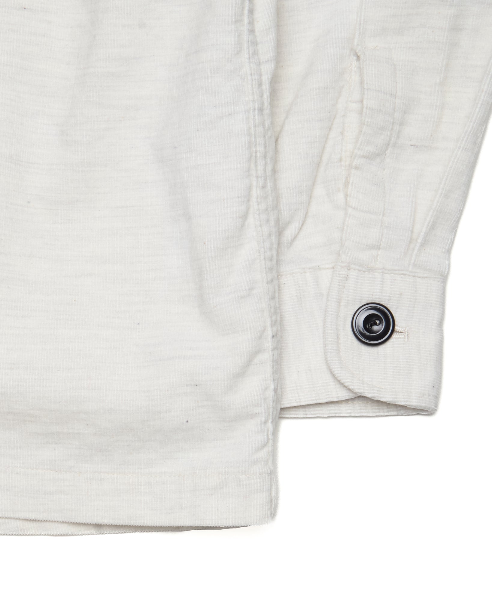 Close-up of a white jacket with a button on a white background