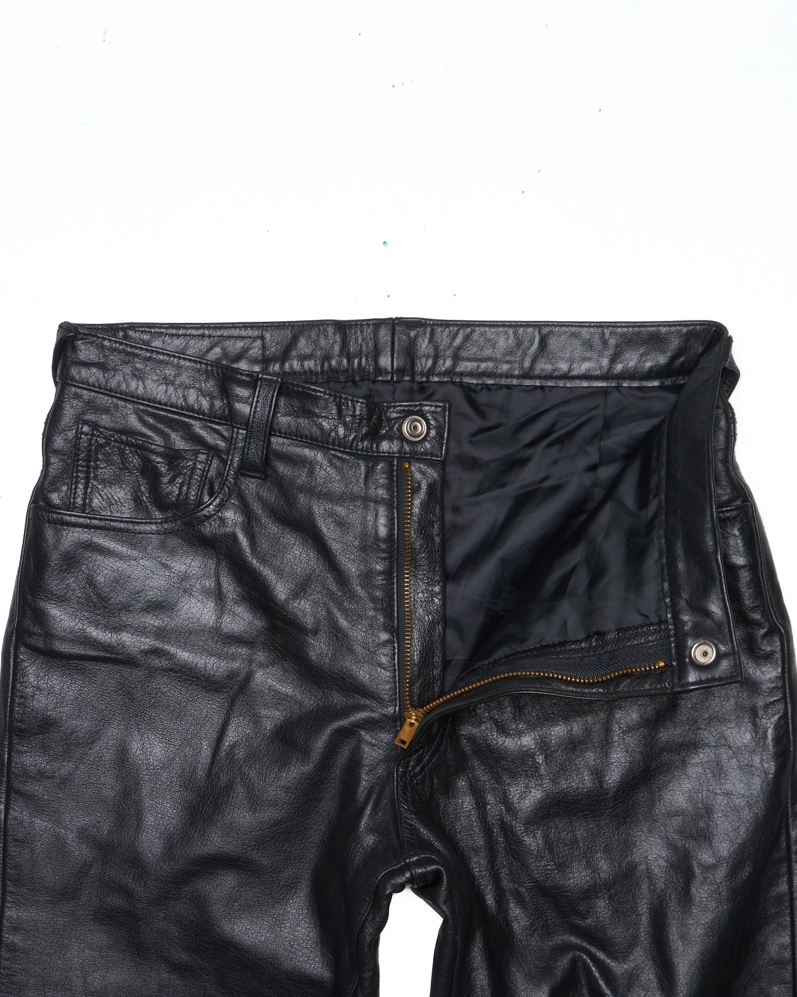 Black leather pants with a zipper on a white background