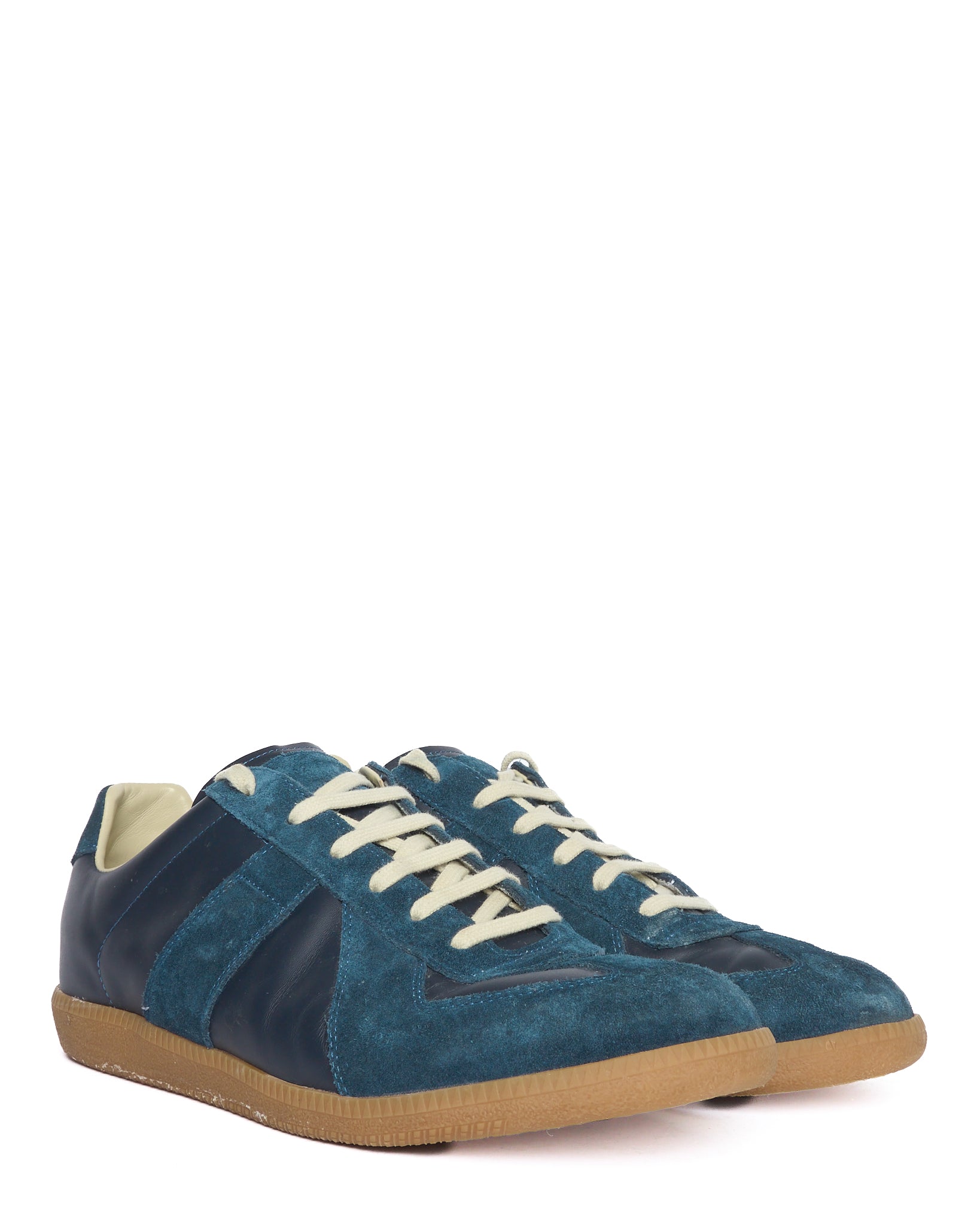 Blue suede sneaker with white laces on a white background