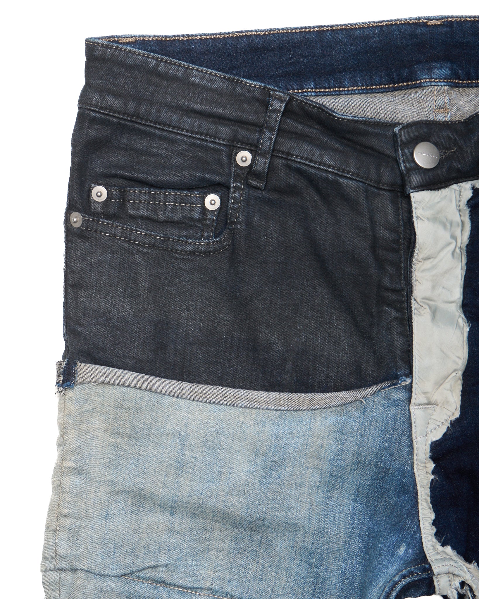 Close-up of a pair of blue jeans with a focus on the waistband and stitching.