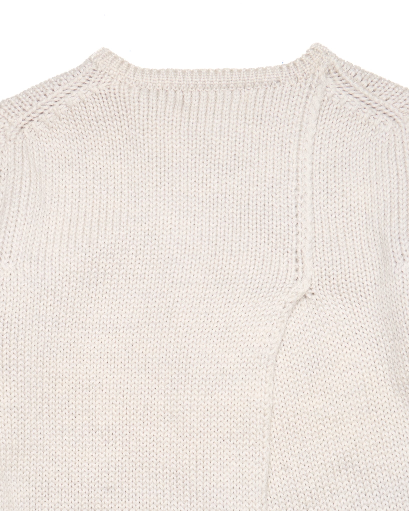 Close-up of a beige knitted sweater on a white background