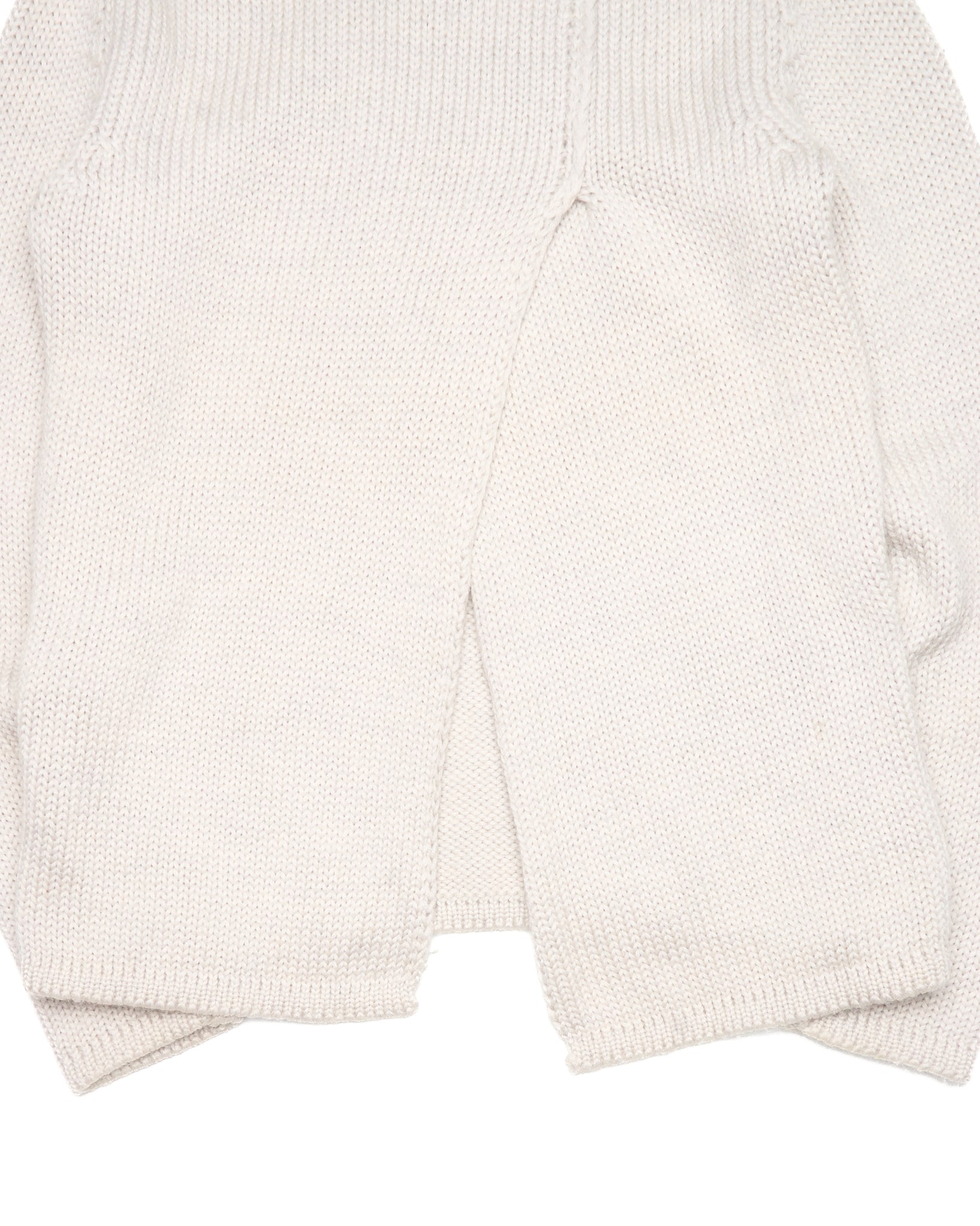 Close-up of a white knit cardigan on a light gray background
